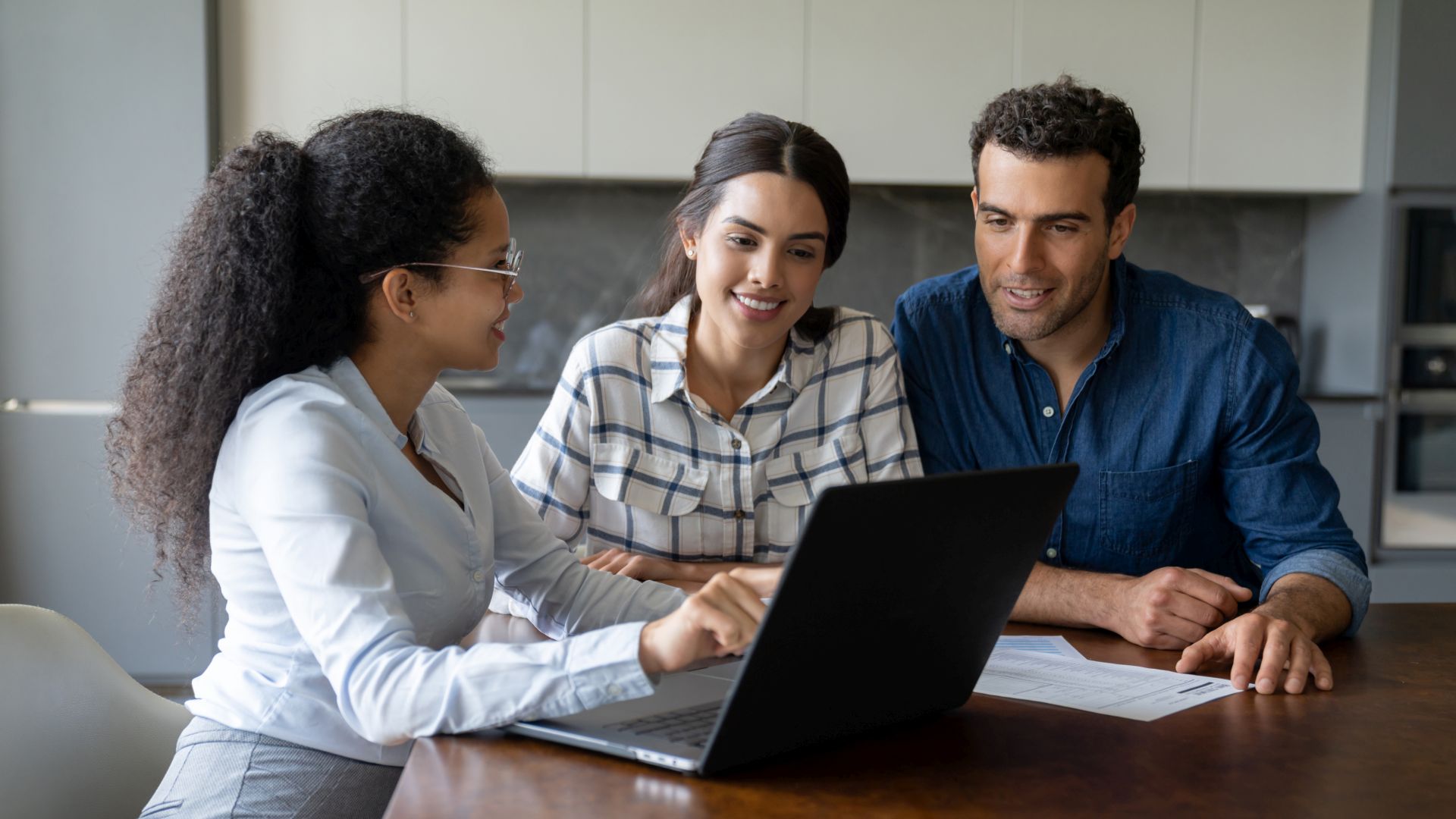 Latin American couple talking to a financial advisor about an investment - home finances concepts.