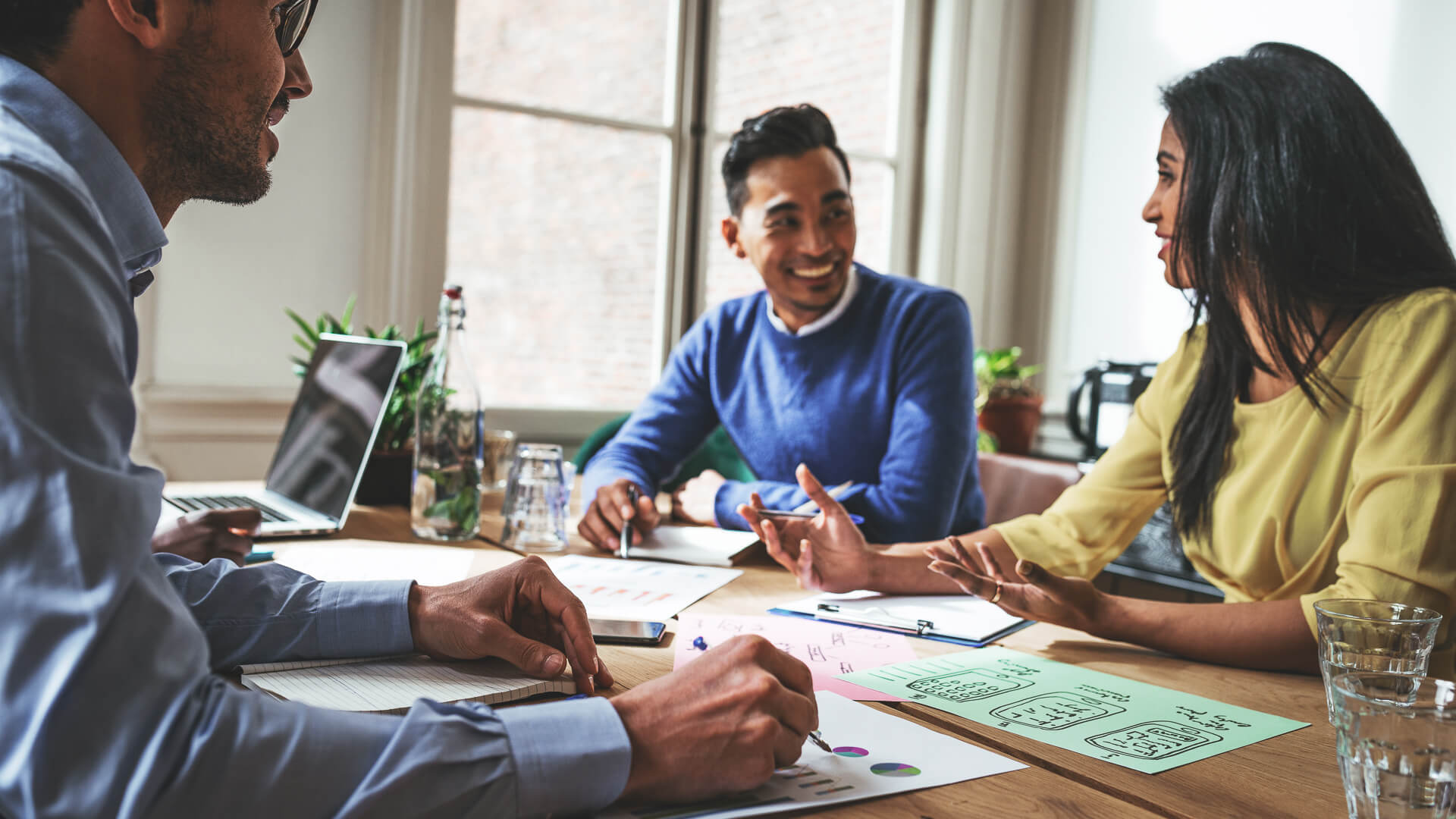 Multi ethnic group of Millennial investors planning new gainful activity.